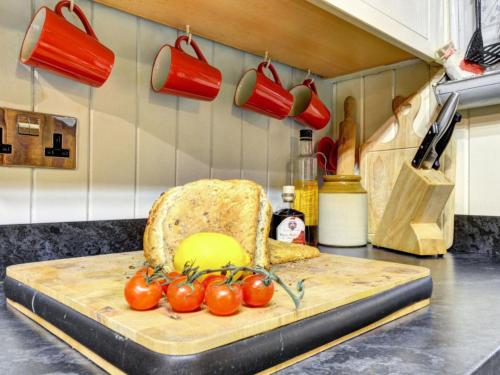 Llanfihangel-y-pennantにあるHoliday Home Dwyford by Interhomeの台所用カウンター(椅子、トマト付)