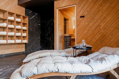 a room with two large beds in a room with wooden walls at Lipowy Dwór in Zakopane