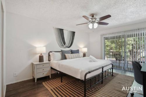 a bedroom with a bed and a ceiling fan at Walk to Everything - Fun Hyde Park Space King Bed in Austin