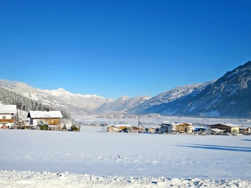 a town in the snow with mountains in the background at Holiday Home Sonnblick by Interhome in Uderns