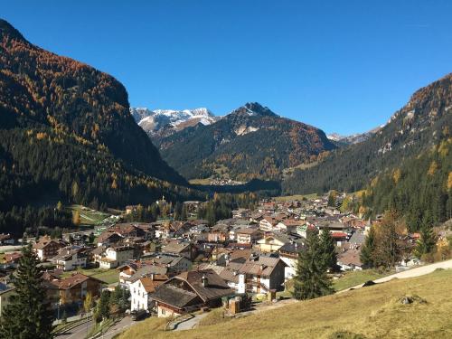 a small town in a valley in the mountains at Apartment Villaggio Ladino by Interhome in Mazzin