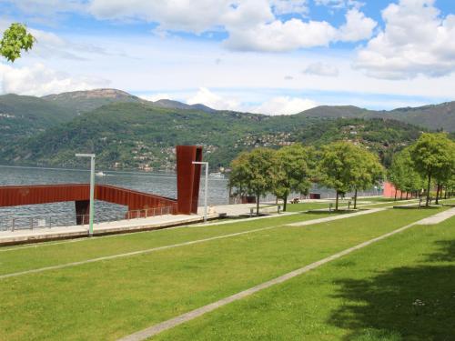 a park with a view of the water and mountains at Apartment Sabina by Interhome in Luino