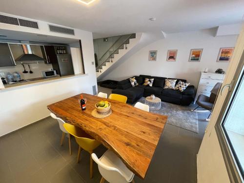 a living room with a wooden table and a couch at Casa-Mont-Roig, new renovated, 5 minutes to beach in Montroig