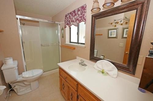 a bathroom with a sink and a toilet and a mirror at 1240 Timber Lane home in South Lake Tahoe