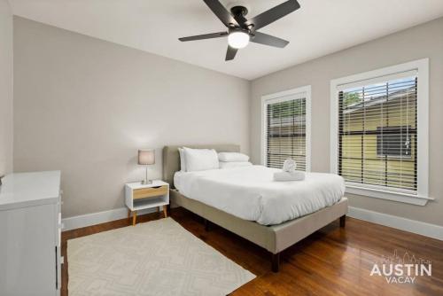 a white bedroom with a bed and a ceiling fan at Gorgeous Home in Heart of Zilker with Full Kitchen in Austin