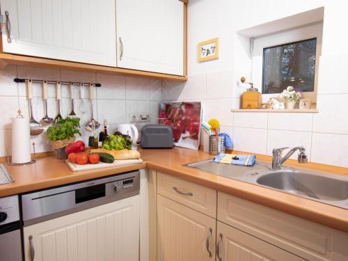 a kitchen with a counter top with vegetables on a cutting board at Holiday Home Bärbel by Interhome in Norden