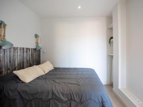 a bedroom with a bed with a wooden headboard at Studio Le Cagnes Beach-1 by Interhome in Cagnes-sur-Mer