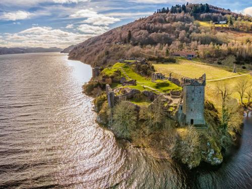 an aerial view of a castle on an island in the water at Chalet Rowan Cottage by Interhome in Inverness