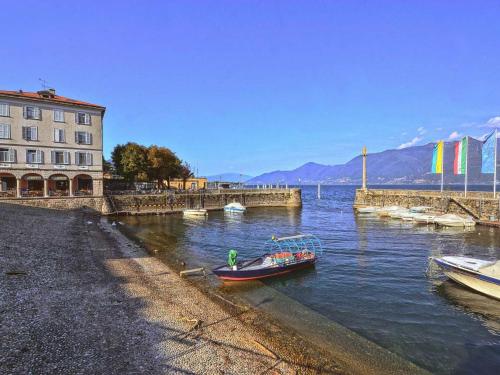 a small boat in the water next to a building at Holiday Home Daniela by Interhome in Luino