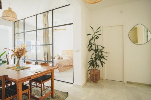 ein Esszimmer mit einem Tisch und einem Spiegel in der Unterkunft Ocean View Ha Apartment in Cádiz