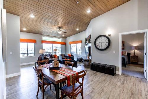 a dining room and living room with a table and a clock at The Penthouse S402 condo in St. George