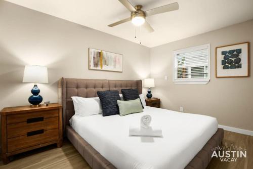 a bedroom with a large bed with a ceiling fan at Remodeled Apt w Gated Community and In-Unit Laundry in Austin