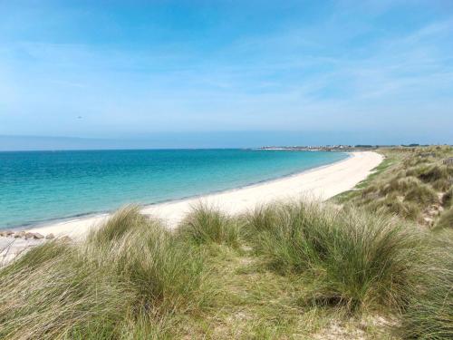 a sandy beach with the ocean in the background at Holiday Home Ty Ruz by Interhome in Plouescat