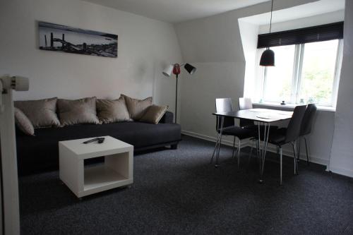 a living room with a couch and a table at 144Nygårdsvej (id.168) in Esbjerg