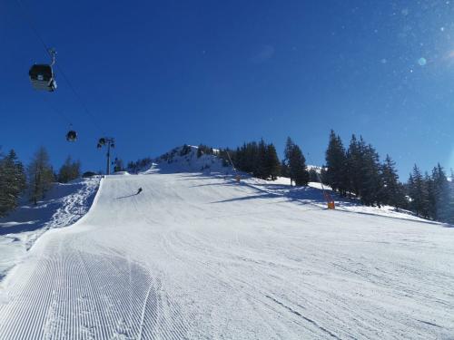 a snow covered ski slope with a ski lift at Apartment Jaggler by Interhome in Dorf