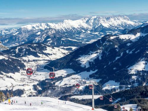 a ski lift on a mountain with snow covered mountains at Apartment Jaggler by Interhome in Dorf