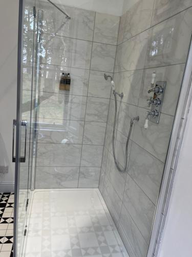 a bathroom with a shower with a glass door at The Farmhouse B&B in Dunkeld