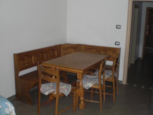 een houten tafel en stoelen in een kamer bij Casa Domenica in Mezzana