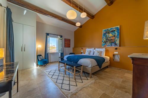 a bedroom with a king sized bed and a table at Marcelle en Camargue in Aigues-Mortes