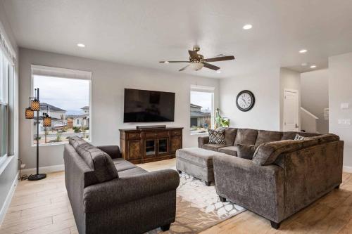 a living room with two couches and a flat screen tv at The Bend at Paseos in Washington