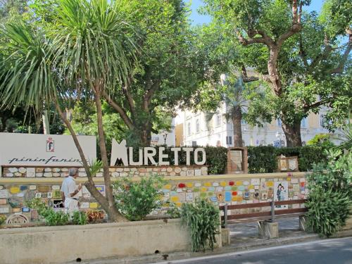 a sign for a nutrition store in a park at Apartment Terrazza sul Molo by Interhome in Alassio