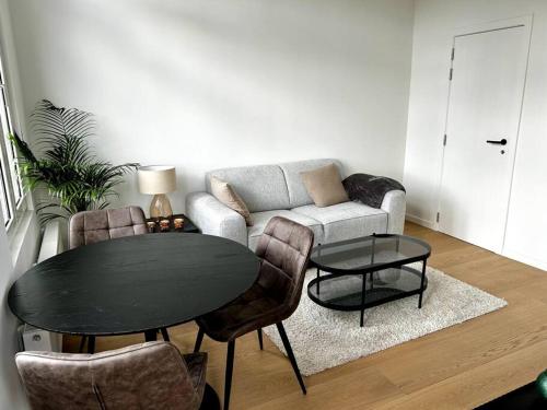 salon ze stołem i kanapą w obiekcie Apartment near central station w Antwerpii