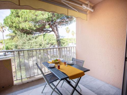une table et des chaises sur un balcon avec un arbre dans l'établissement Studio Port de La Gavine-24 by Interhome, à Hyères