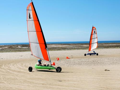 two sailboats on the beach with a person driving a boat at Holiday Home Le havre de paix by Interhome in Créances