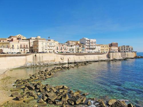 a group of buildings on the shore of a body of water at Villa Smeraldo by Interhome in Siracusa
