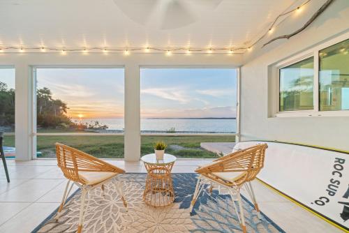 a dining room with a view of the ocean at Bella Mer home in Savannah Sound