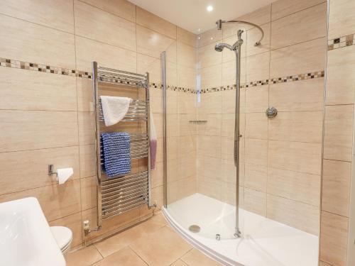 a bathroom with a shower and a toilet and a sink at Bottle Tops in Windermere