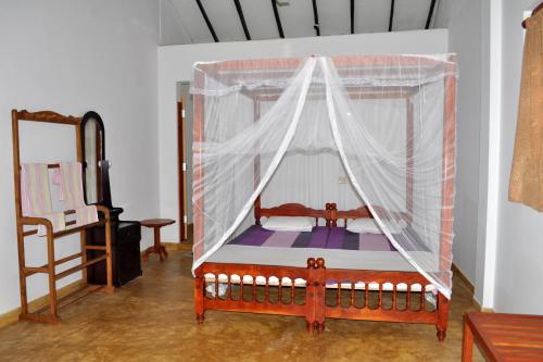 A bed or beds in a room at Dilena Beach Inn