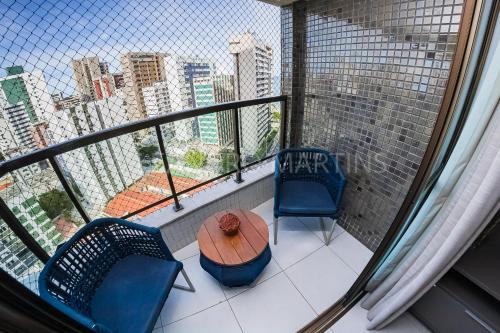a balcony with two chairs and a table on a balcony at Apartamento Royale na praia de Boa Viagem in Recife