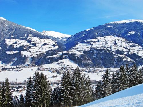 a snow covered mountain range with trees and a town at Apartment Sonnigs Platzl by Interhome in Stumm