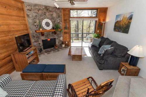 a living room with a couch and a fireplace at Seven Springs Swiss Mountain 1 Bedroom Standard Condo, Mountain Views! condo in Champion