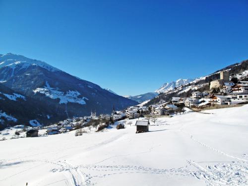 a village in the snow with mountains in the background at Apartment FeWo Anna by Interhome in Fliess