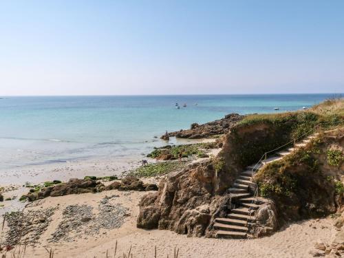 a set of stairs leading down to the beach at Holiday Home La petite Iroise by Interhome in Plogoff