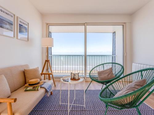 a living room with a couch and two chairs at Apartment Les Mouettes by Interhome in Jullouville-les-Pins