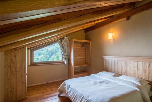 a bedroom with a bed and a large window at Civico 9 in Marmora