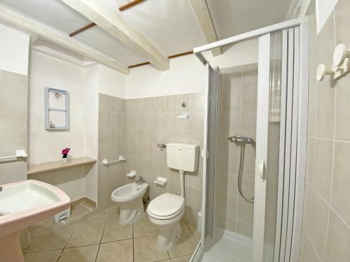 a bathroom with a toilet and a sink and a shower at Mareantico Shabby Apartment in Sampieri