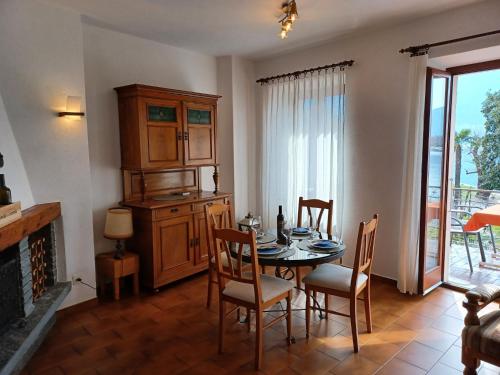 a dining room with a table and chairs and a fireplace at Apartment Appartamento da Reto by Interhome in Muralto