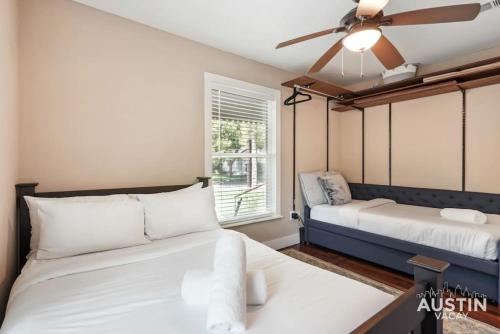 a bedroom with two beds and a ceiling fan at Sizable Screened in Porch w Luxury Kitchen and Bath in Austin