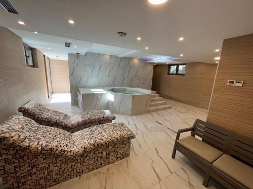 a living room with a couch and a tub at STUDIO 33 Luxury&Spa in Zlatibor