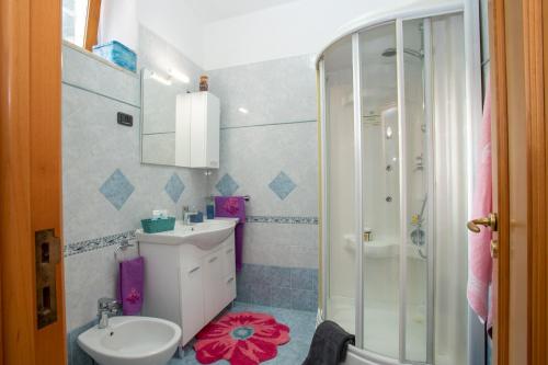 a bathroom with a sink and a toilet and a shower at Mamma Rosa Be Home in Salerno