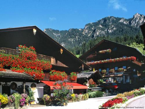 a woman standing in front of a building with flowers at Apartment Theresia by Interhome in Alpbach
