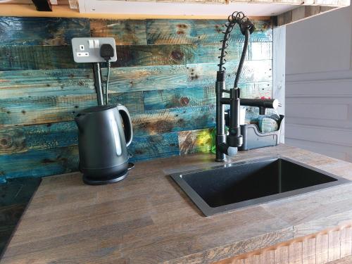 a kitchen with a sink and a water fountain at The Malvern Hills, Courtyard Cabins,Tom Cabin in Great Malvern