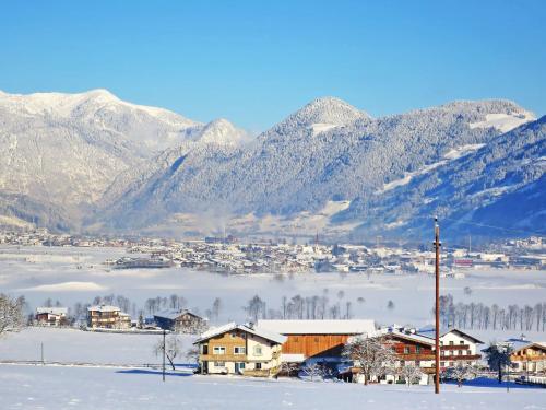 a town in the snow with mountains in the background at Apartment Moarerlechenhof-1 by Interhome in Hart im Zillertal