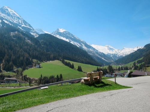 a bench on the side of a road with mountains at Chalet Lippnerhütte by Interhome in Tux