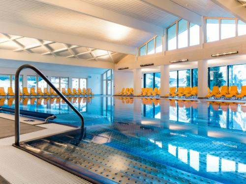a large indoor swimming pool with blue water at Apartment Haflingerhof Edelweiß by Interhome in Kaunertal