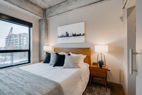 a bedroom with a bed and a large window at Sable 48 in Minneapolis